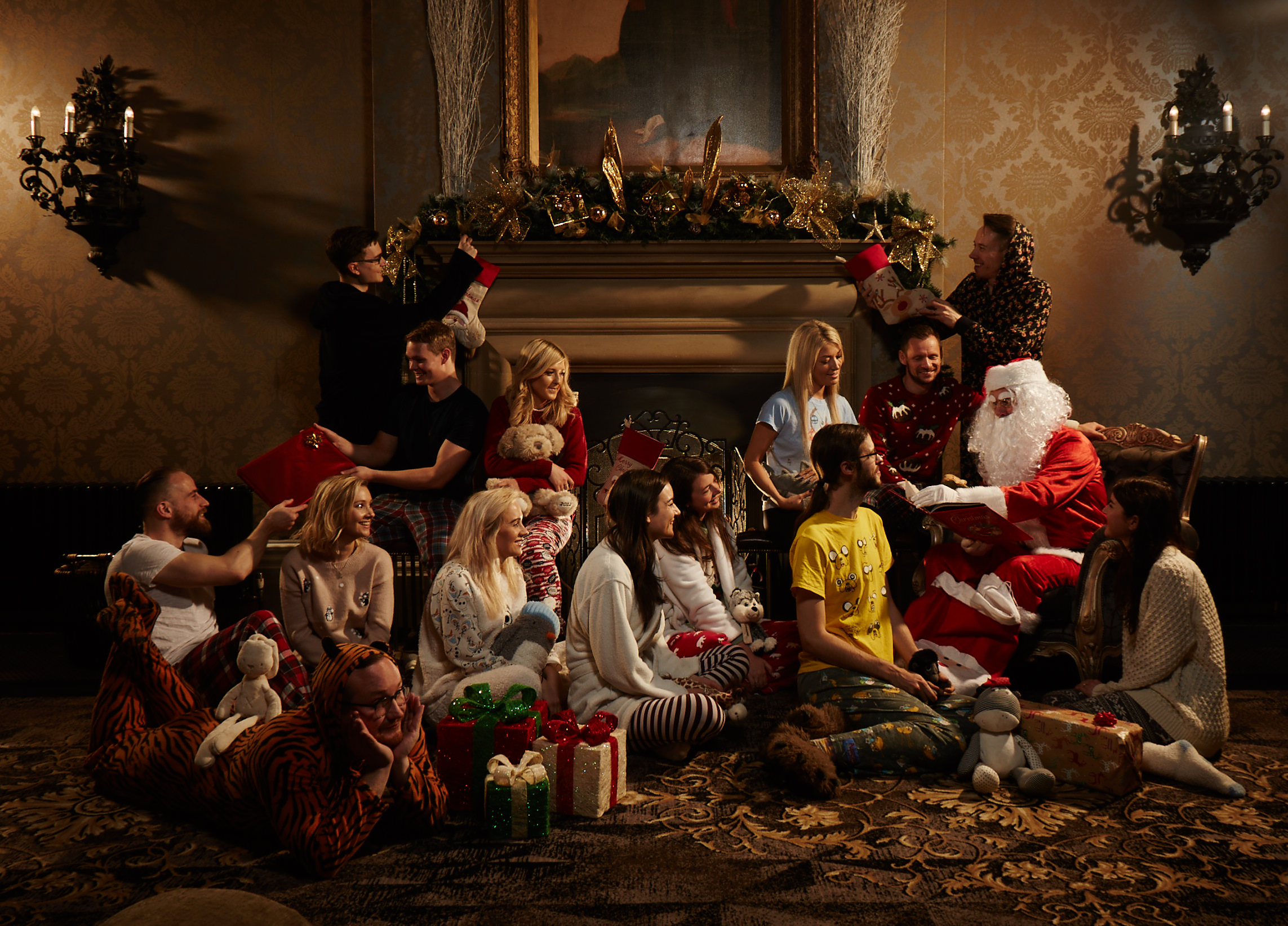 The Staff of We Are Boutique in Pyjamas Gathered Around Santa as he Reads a Story 