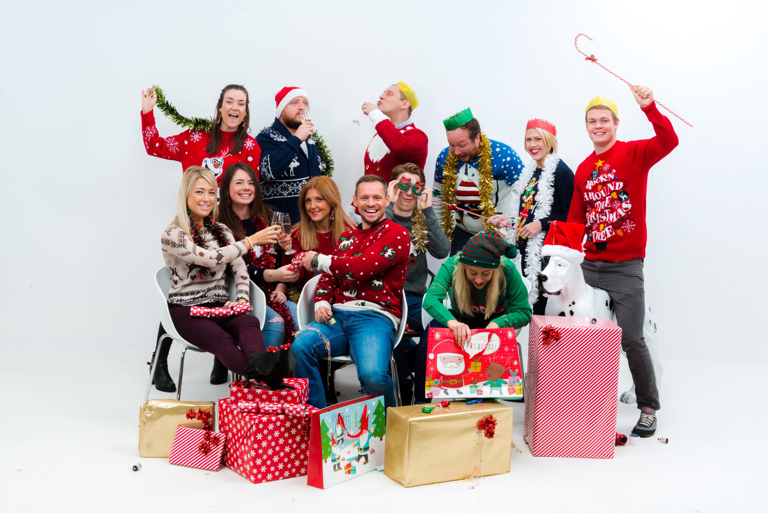 The staff of We Are Boutique looking joyus in christmas jumpers opening presents