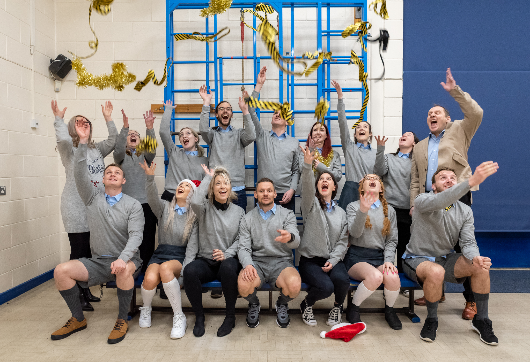 The Staff of We Are Boutique dressed up as School Children, throwing their ties in the air, looking joyous. 