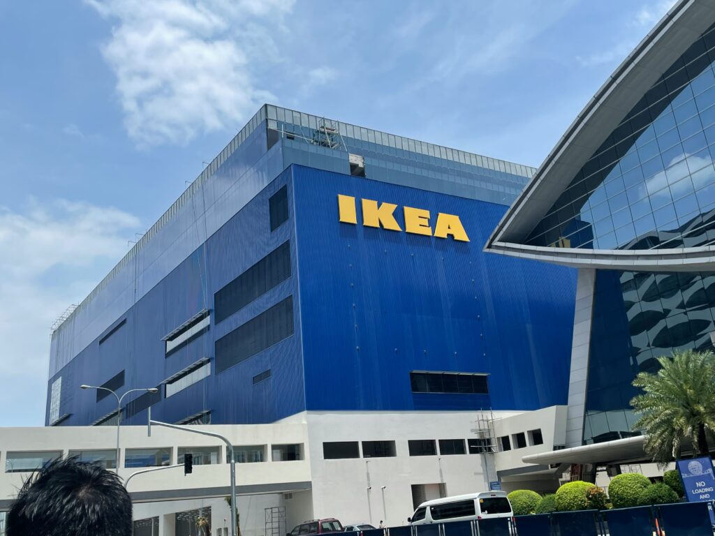 IKEA: Large blue warehouse with yellow IKEA logo on the side, with blue skies in background